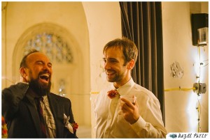 Two men laughing hard in wedding clothing