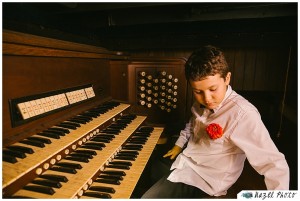 Boy sitting at an organ flower in shirt
