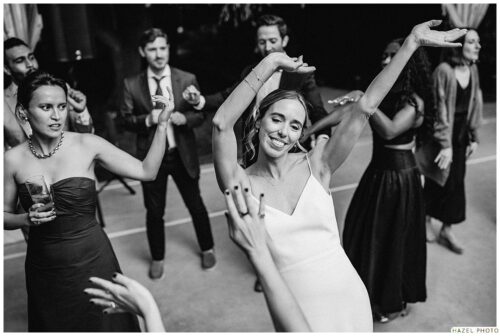 bride dancing with arms in the air
