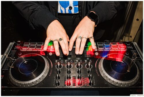 close up of DJs hands on mix table wedding
