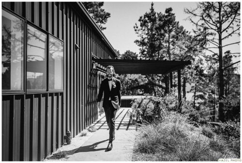 groom with lodge in background