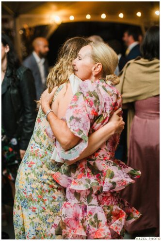 wedding guests embrace on the dance floor