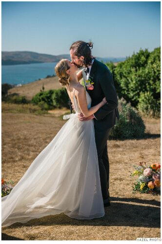bride and groom kiss at ceremony