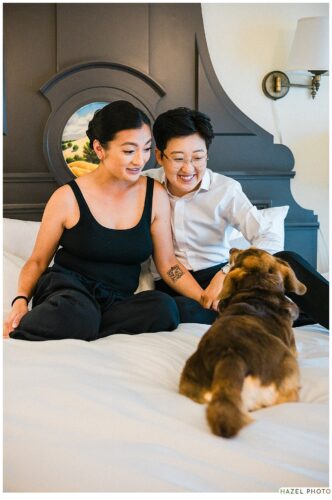 wedding couple photoshoot with dogs on bed at fairmont inn