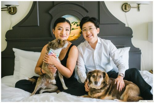 wedding couple photoshoot with dogs on bed at fairmont inn