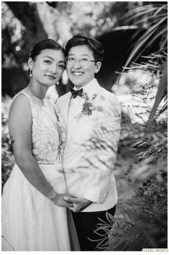 portrait of wedding couple among art in the cornerstone garden