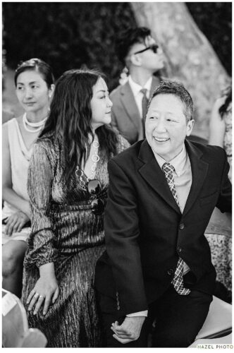 seated wedding guests eagerly anticipate the couple