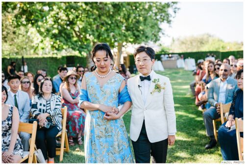 partner walks down the aisle with her mother