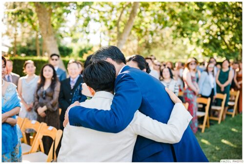 father hugs newlywed