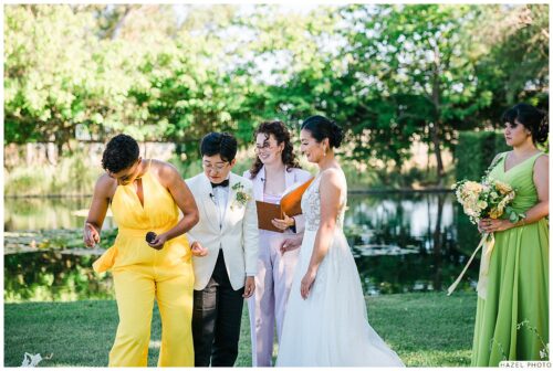 image of wedding couple laughing as bridesmaid drops ring during ceremony
