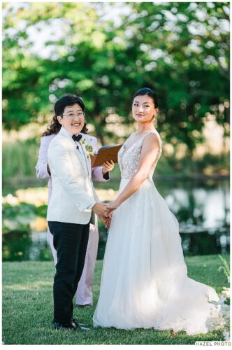 wedding couple during ceremony, holding hands