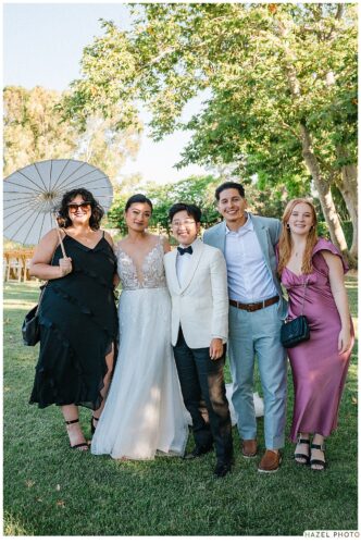 portrait of newlyweds with friends after the ceremony