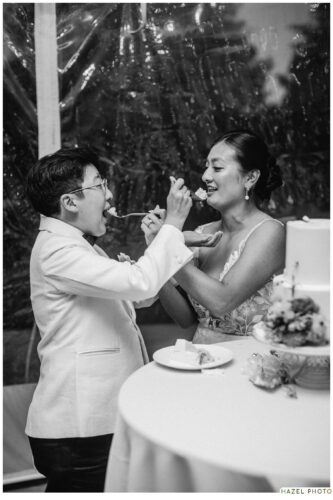 newlyweds feeding each other a bite of cake