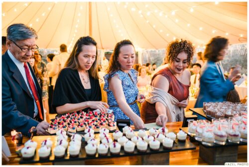 wedding guests at the dessert table