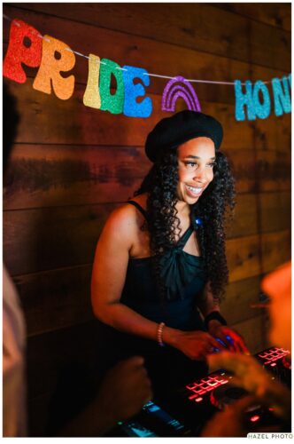 portrait of heart of gold DJ under a banner saying "[it's] pride honey"