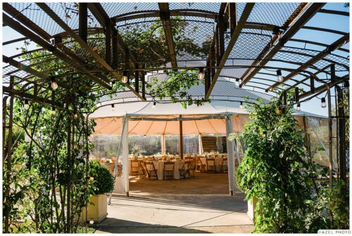 daytime landscape shot of the reception area under a large white tent at cornerstone garden